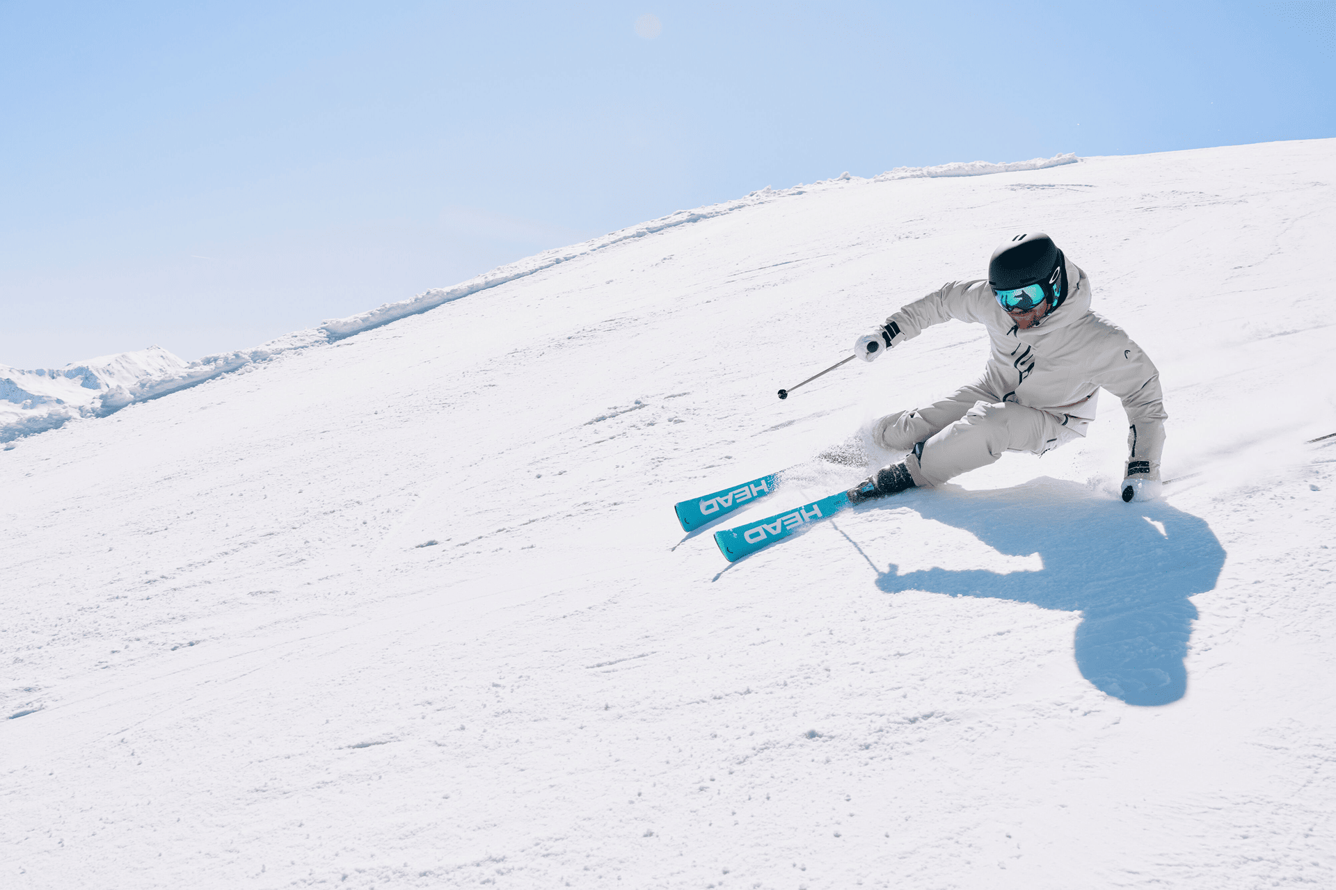 Skier in bright clothing skiing down the slope