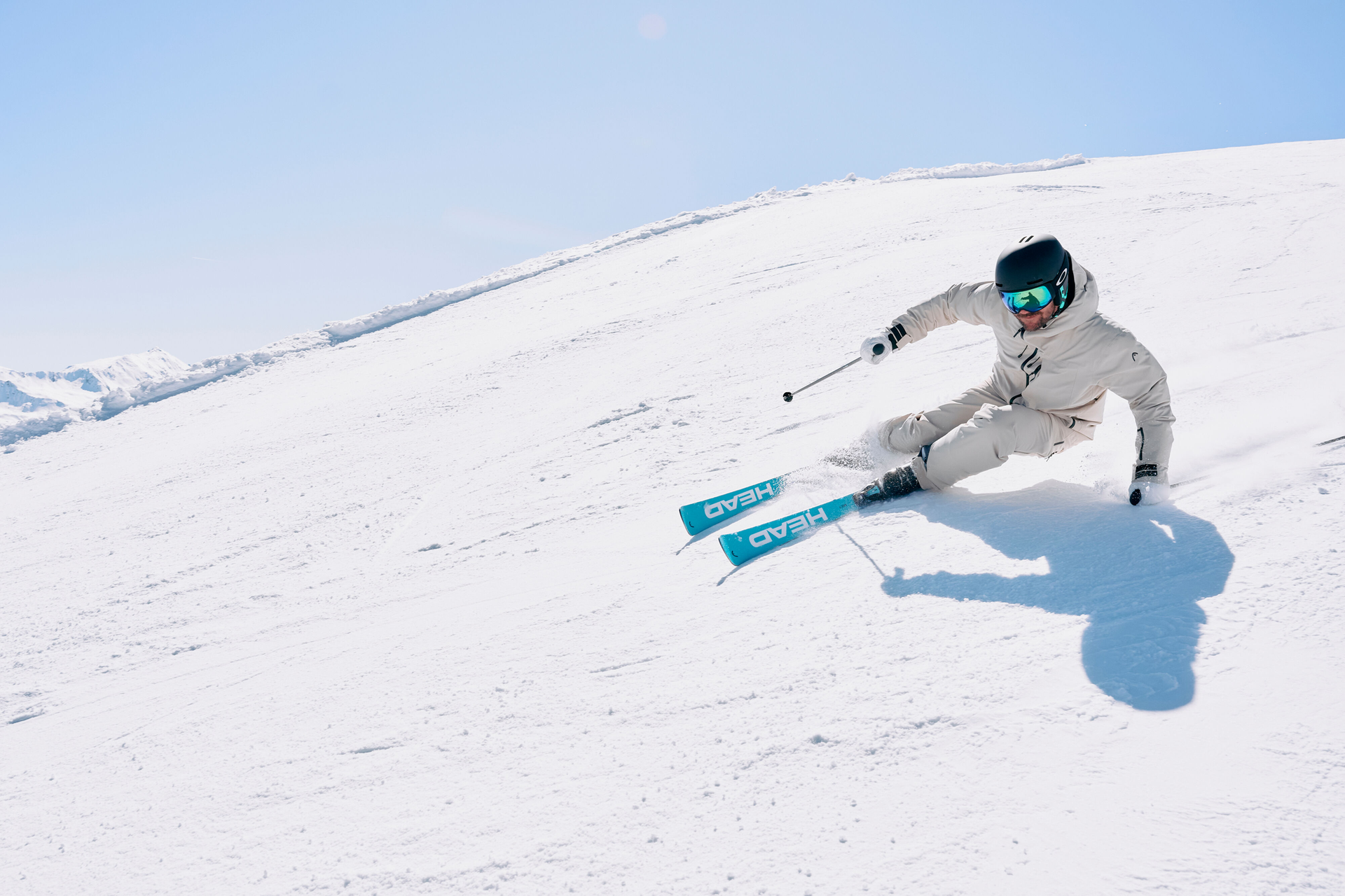 Skier in bright clothing skiing down the slope