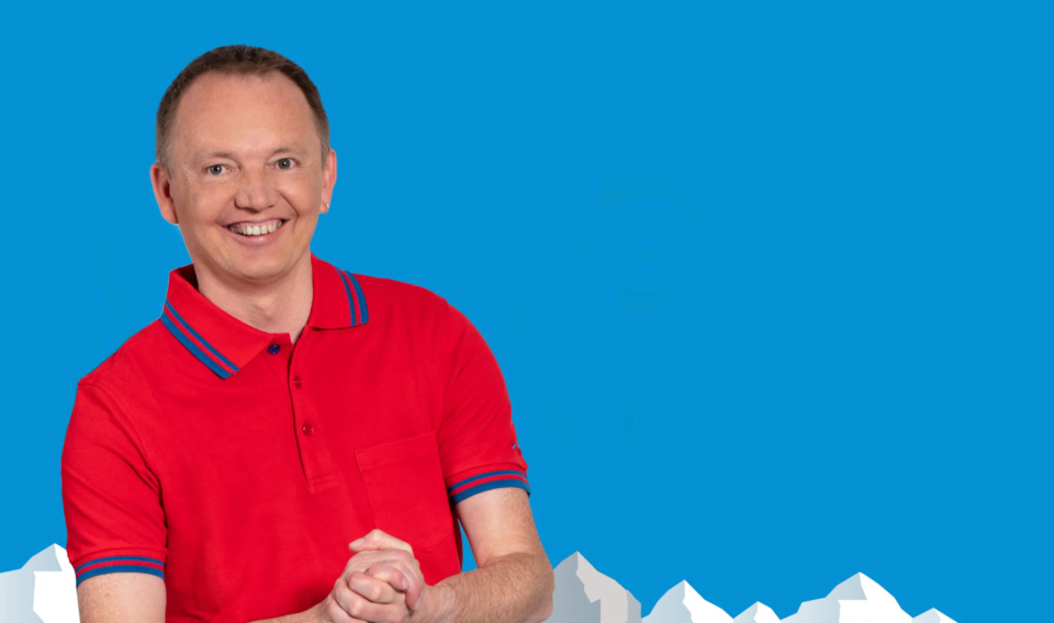 Owner wearing a red shirt, light blue background