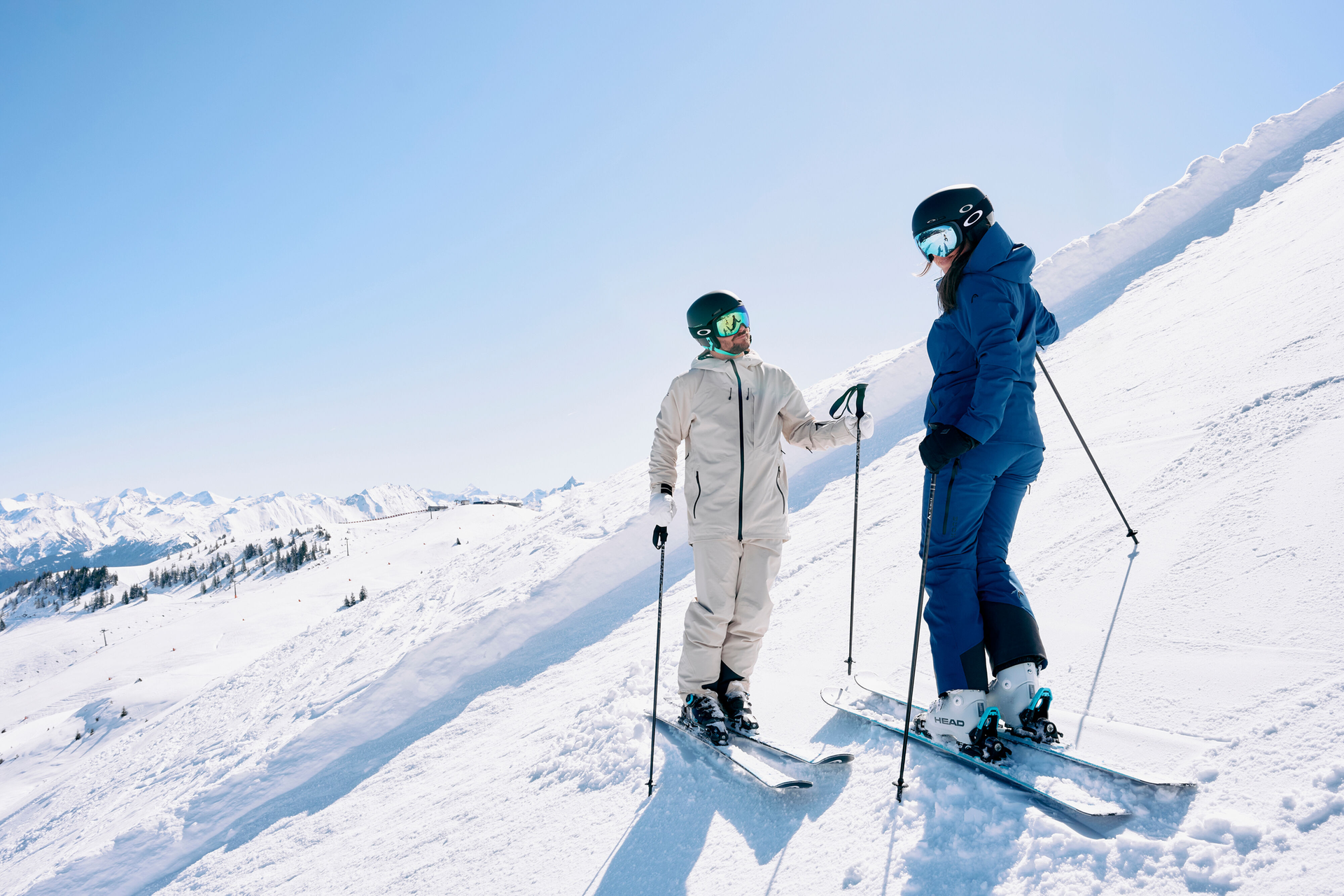 Two skiers standing on the slope, looking at each other