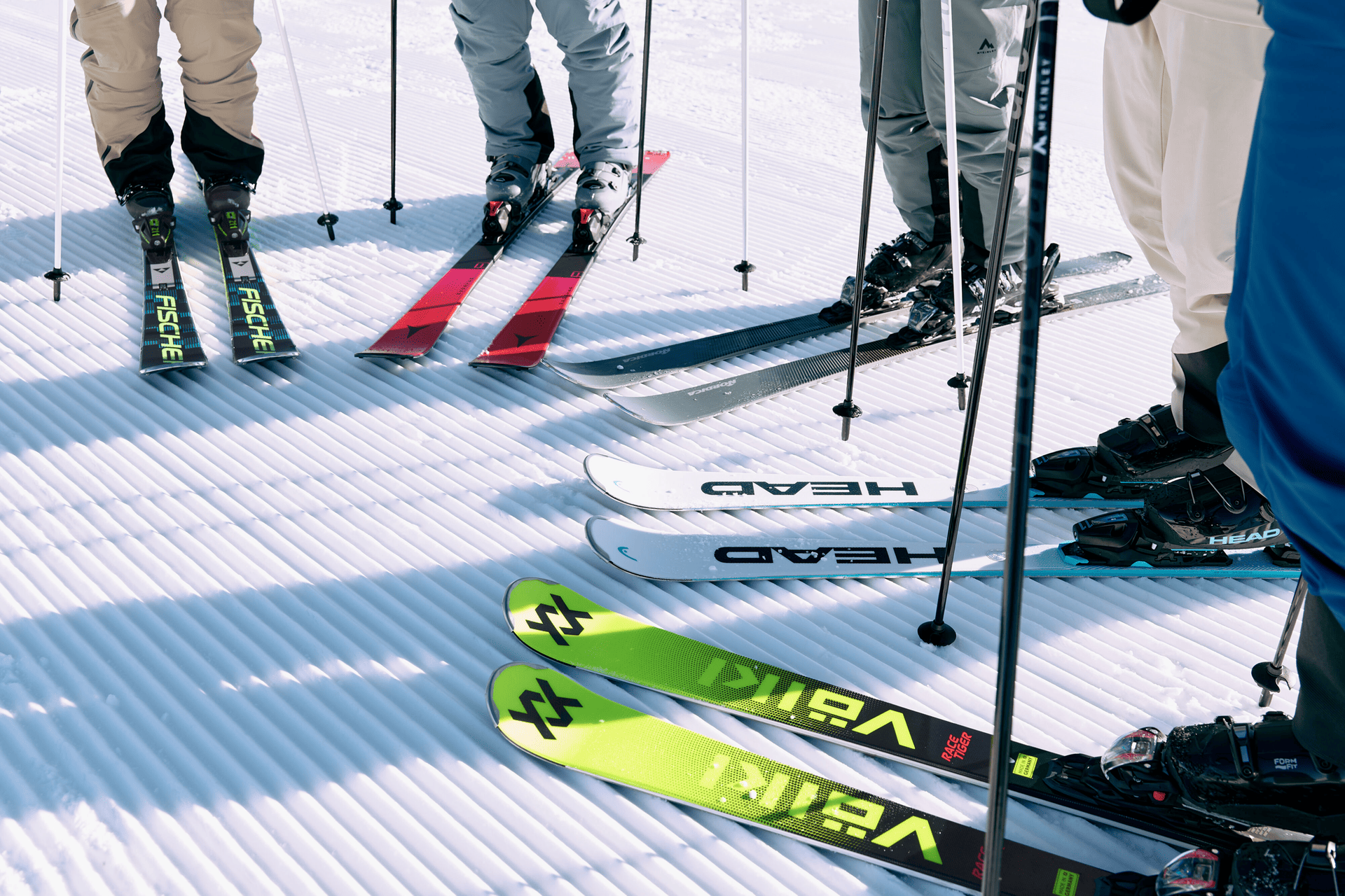 Close-up of skis in different colors in the snow